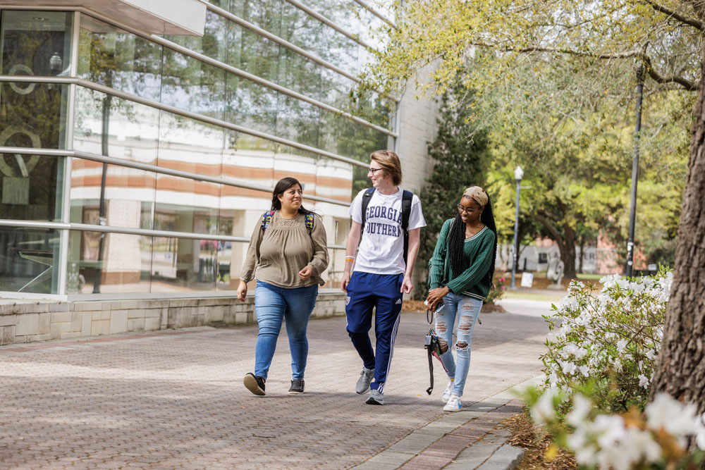 Group of Georgia Southern University students walking on campus, showcasing a vibrant college atmosphere and student life.