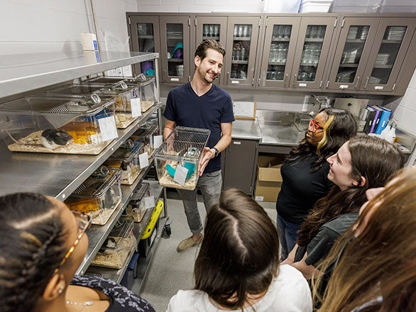 A research assistant shows College of Behavioral and Social Sciences undergraduate students the animals in a research laboratory at Georgia Southern