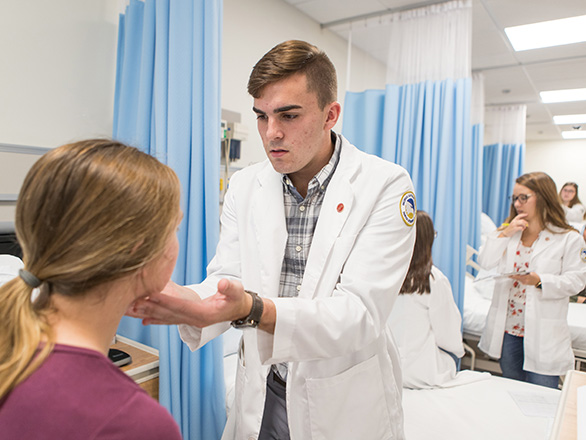 Students from Georgia Southern's Waters College of Health Professions practice examining patients in a clinical environment