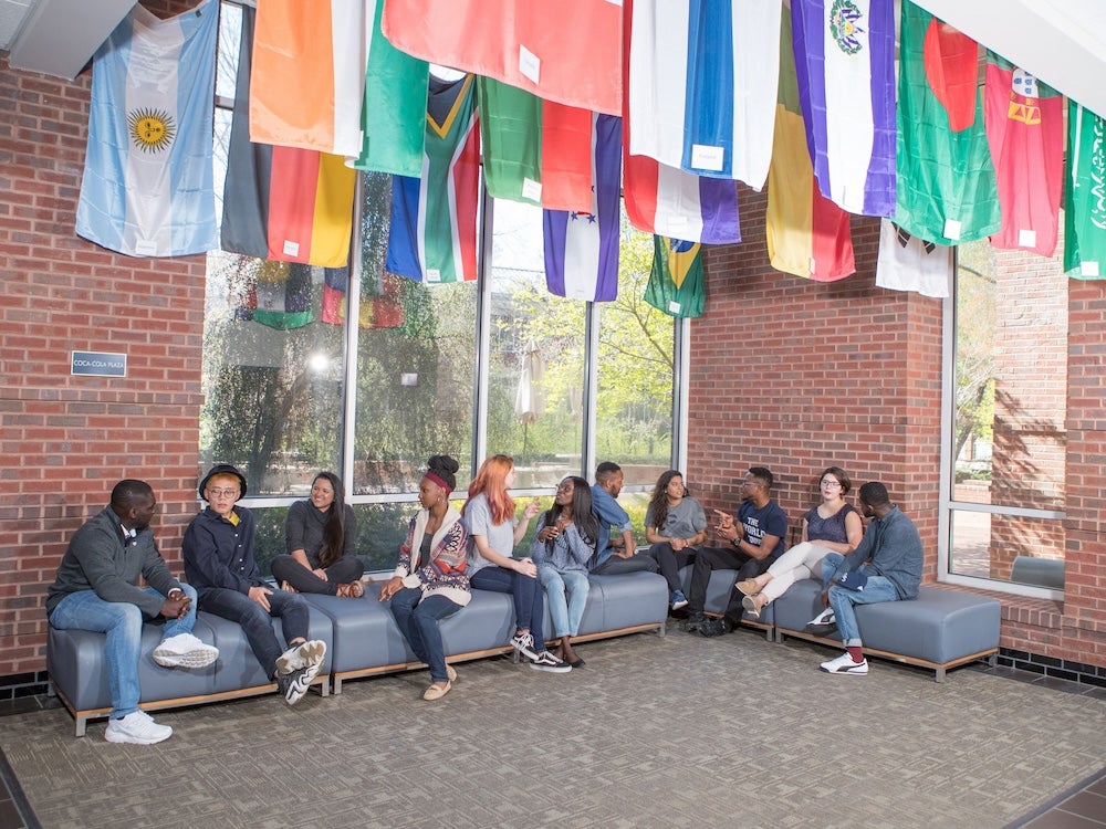 Students from Georgia Southern's B.A. in World Languages and Cultures, Spanish Concentrations and other programs congregate in a common area filled with flags