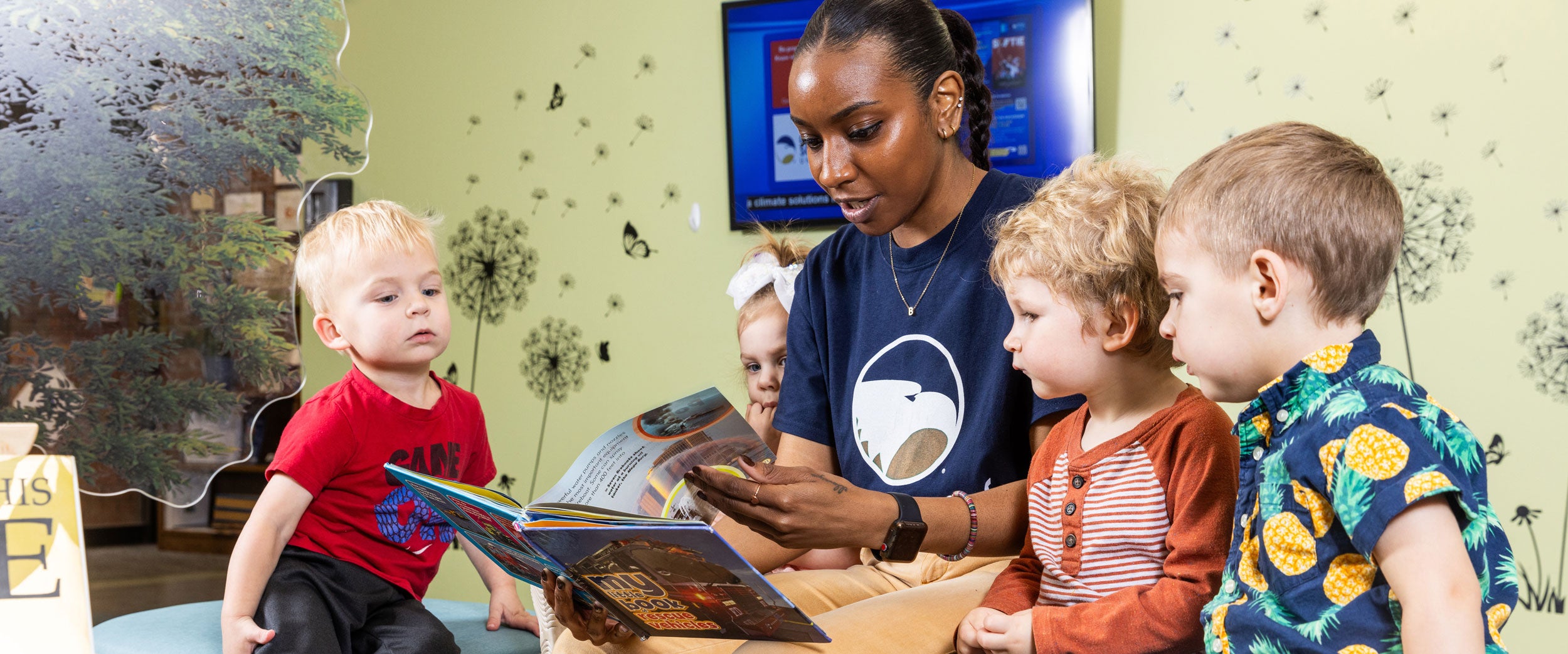 A student in Georgia Southern's B.S. in Human Development and Family Science program reads to four toddler-age children