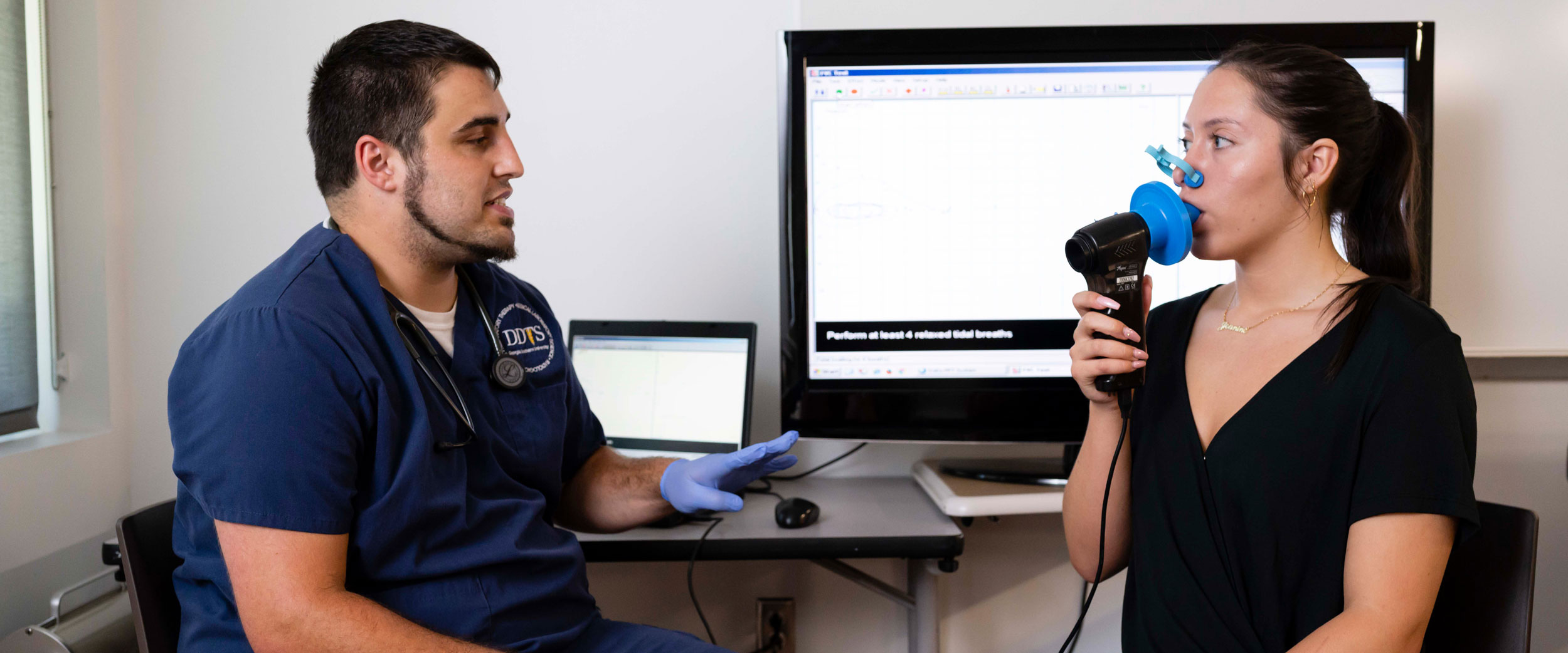 Two students from Georgia Southern's B.S. in Respiratory Therapy program practice assessing patient breathing with industry-standard tools