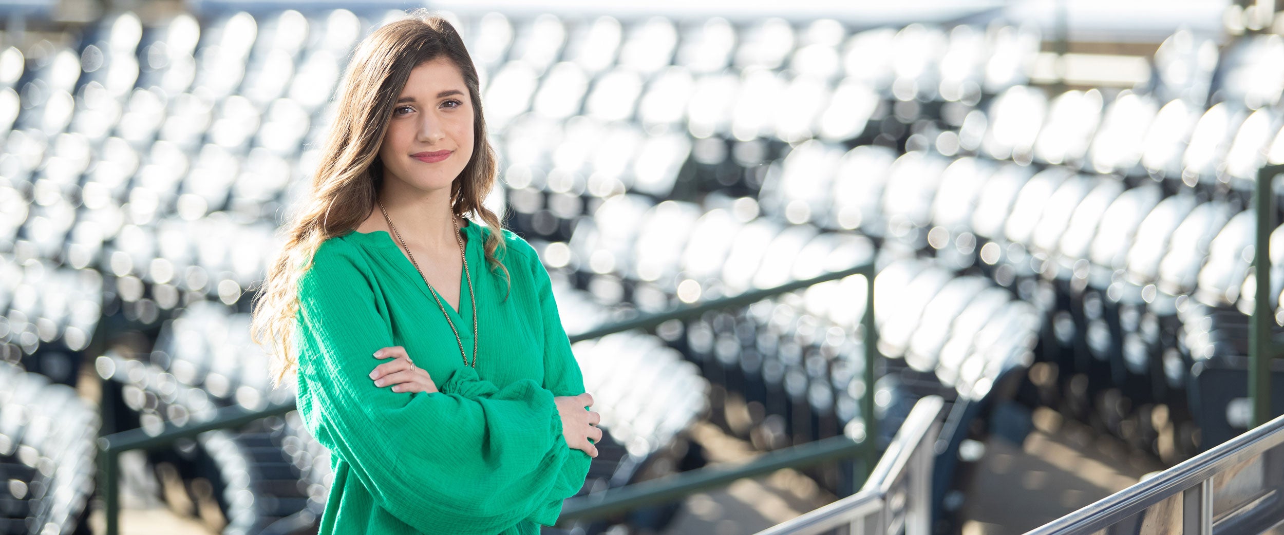 A student from Georgia Southern's B.S. in Sport Management program stands among stadium seats