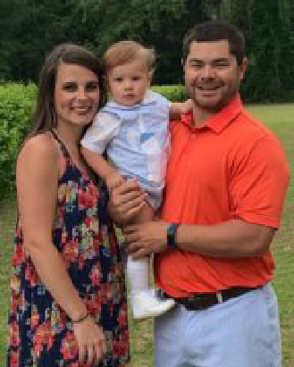 Georgia Southern MAT alum Benjamin Mitchell, ’20, stands outdoors with his family