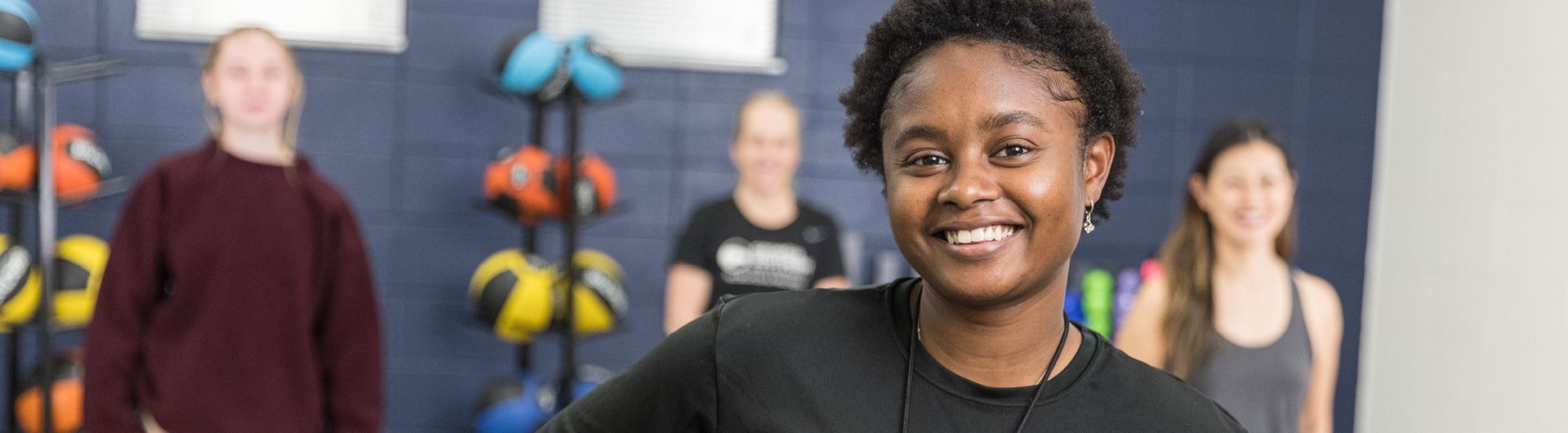 Students from Georgia Southern's M.S. in Athletic Training program smile in a training environment.