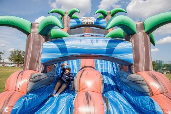 Georgia Southern student goes down an inflatable slide at the Fall Family Weekend event.