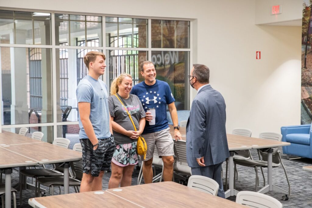 Georgia Southern student, his mother and father meet with President Dr. Kyle Marrero during parent and family night.