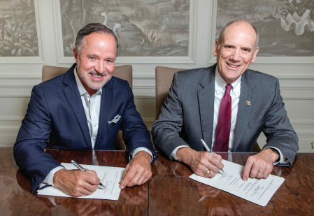 Greg Parker, president, founder and CEO of The Parker Companies in Savannah, and Allen C. Amason, dean of the Gregory M. Parker College of Business, sign the historic agreement.