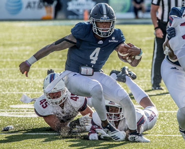 A Georgia Southern football player escapes a tackle during a game