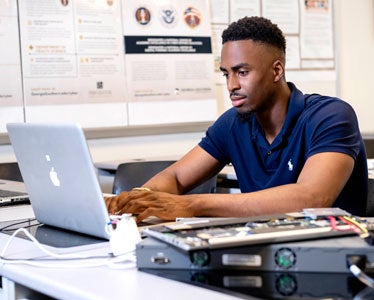 In Georgia Southern's Center for Applied Cyber Education, a B.S. in Information Technology student learns about protecting networks against vulnerabilities.