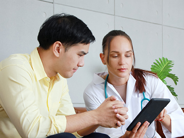 During a clinical practicum assignment, a student from Georgia Southern's M.S. in Psychology, Behavior Analysis reviews notes on a tablet with a medical professional.