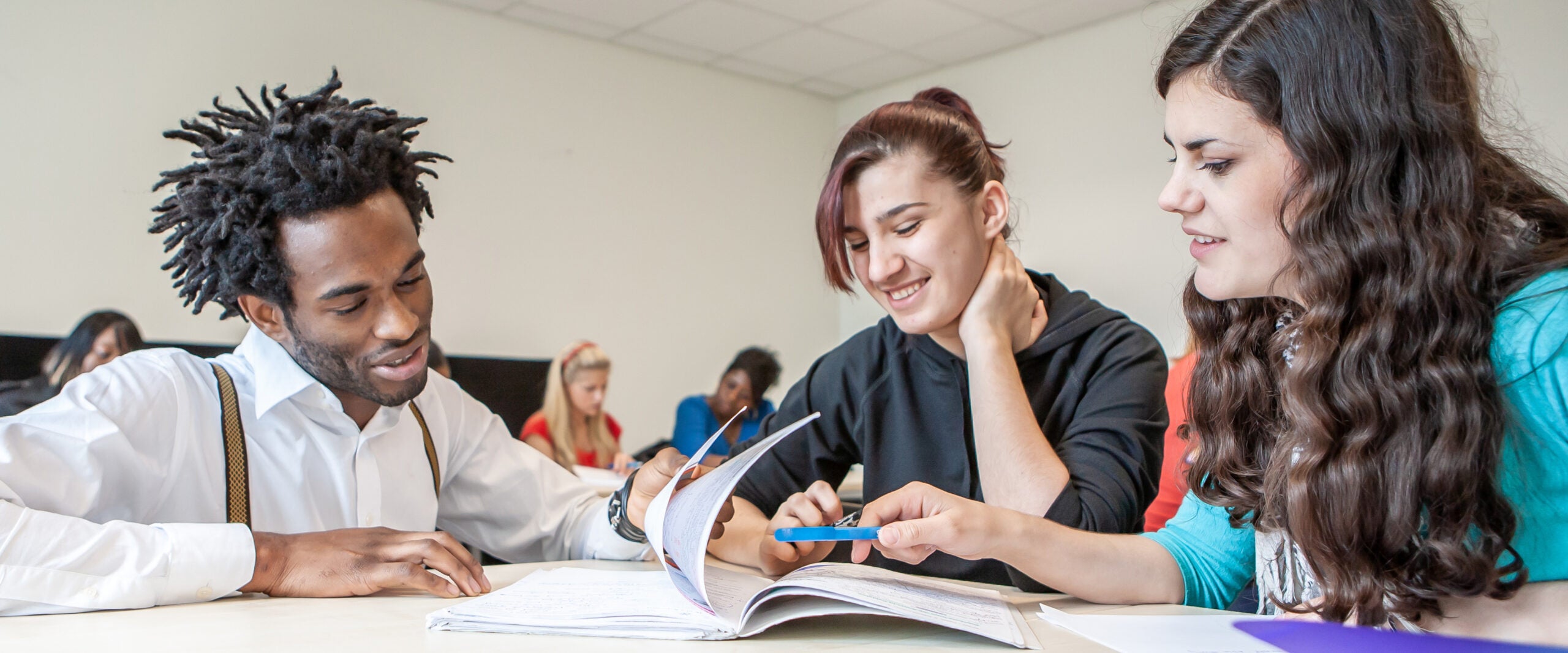 group of ethnically diverse georgia southern students in classroom setting, studying english together and learning as a group