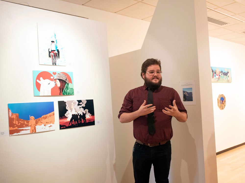 georgia southern student presenting art features during art exhibit, in an art gallery