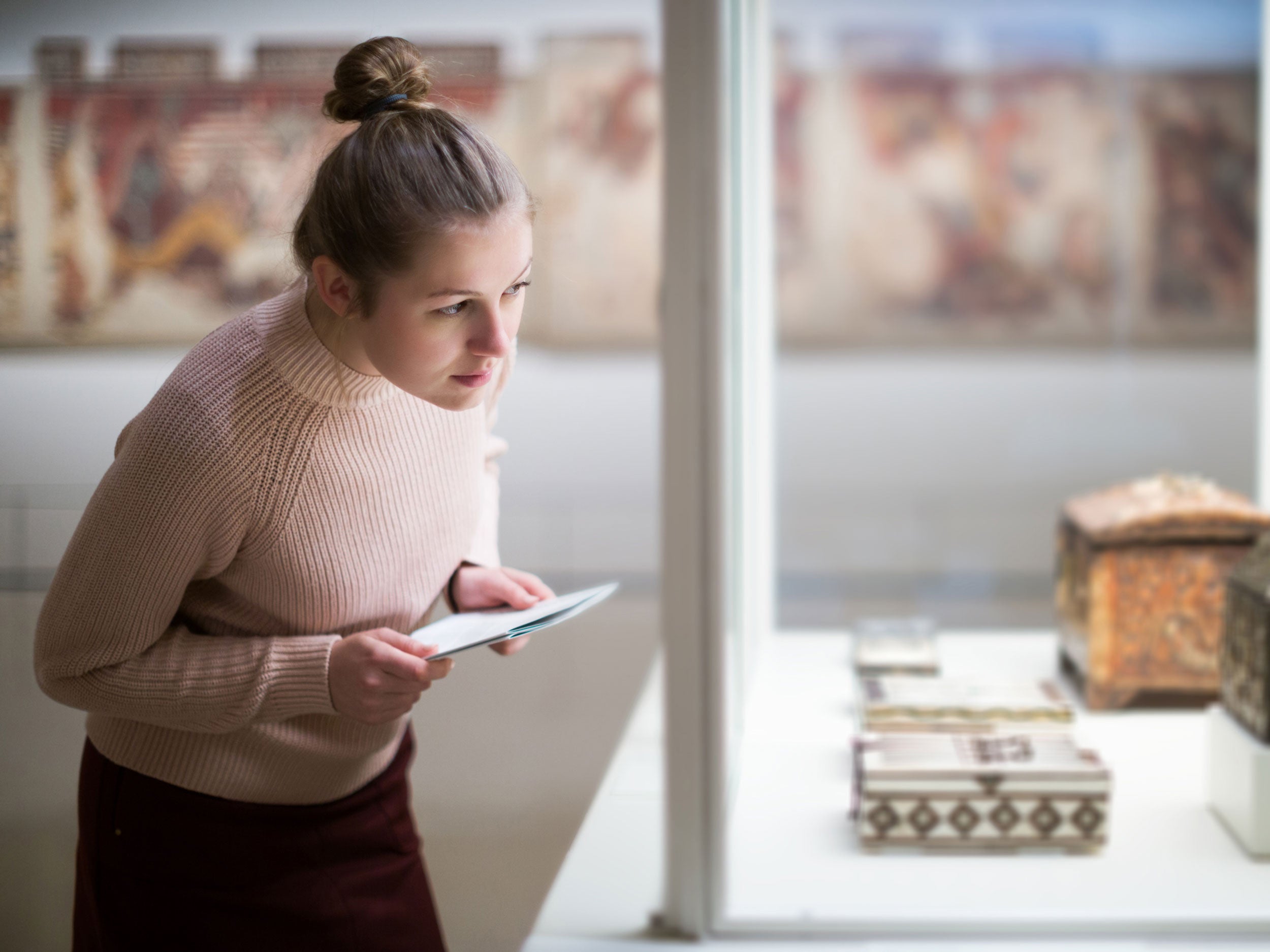 Georgia Southern art history student studying historical art piece at an on-capus museum.