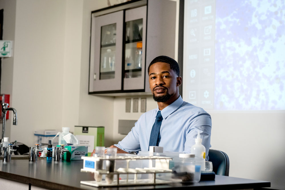 Georgia Southern student in lab sitting at work bench.