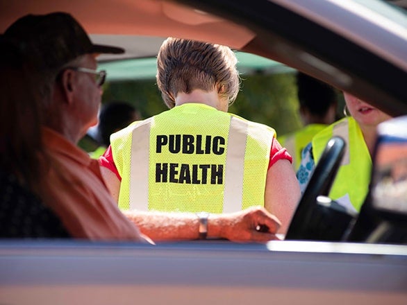 Wearing hi-vis vests, students from Georgia Southern's Jiann-Ping Hsu College of Public Health interact with community members during an outreach initiative