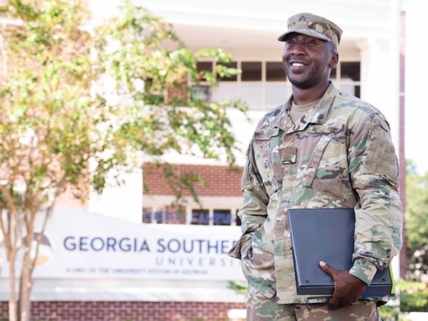 A student in a military uniform stands outside Georgia Southern's Liberty Campus