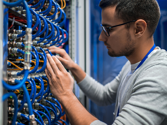 A student from Georgia Southern's M.S. in Electrical and Computer Engineering program adjusts a series of connectors