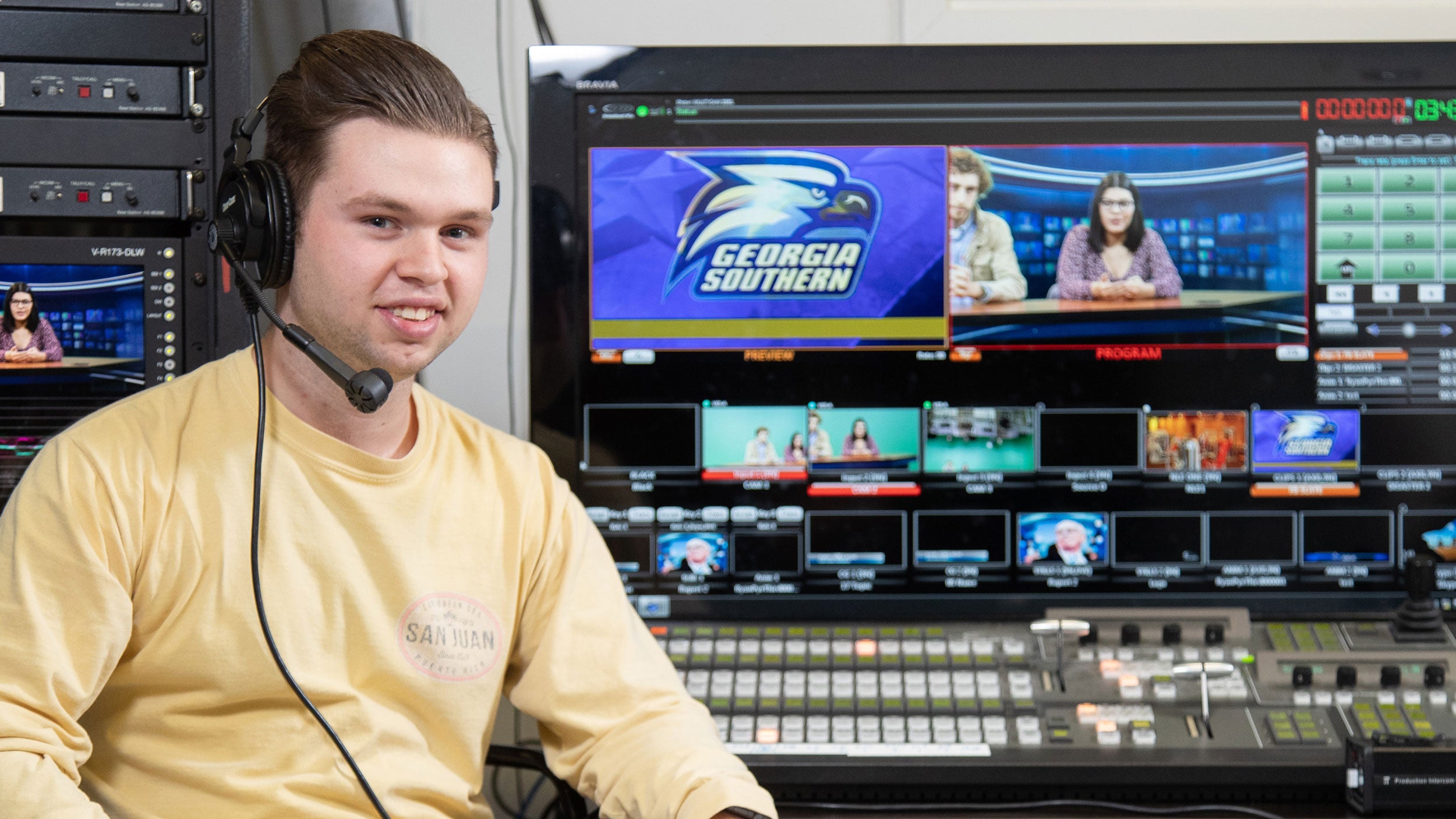 georgia southern student in multi-media room, in headset for production