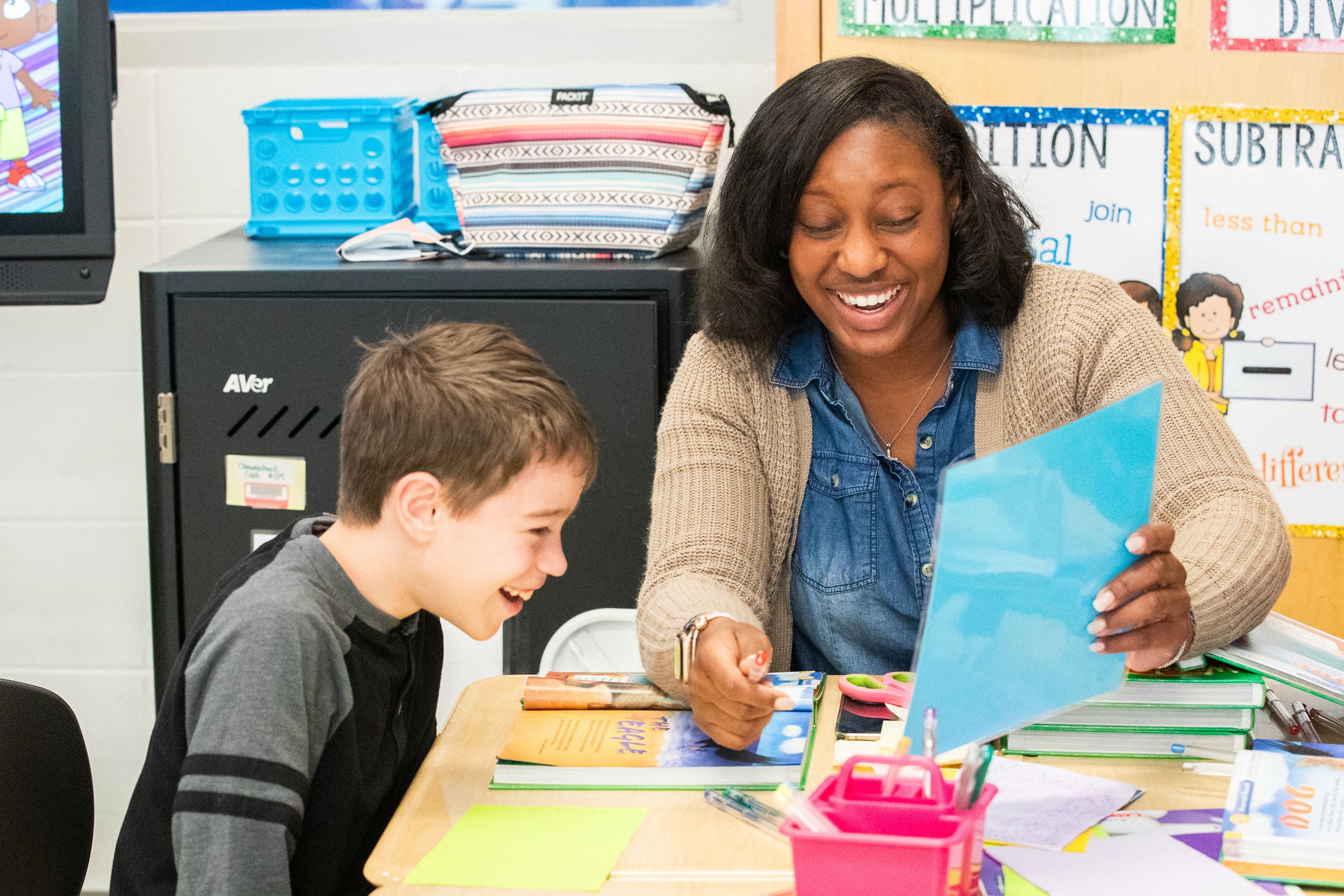 A Georgia Southern student teacher with a student at a desk working together.