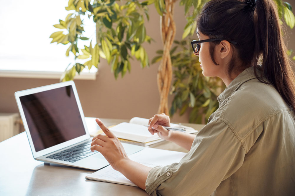 A staff member from Georgia Southern's Counseling Center types on a laptop at a desk