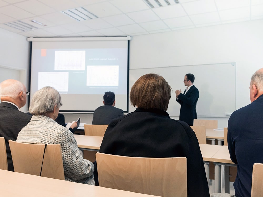 A man presents data to a classroom of people