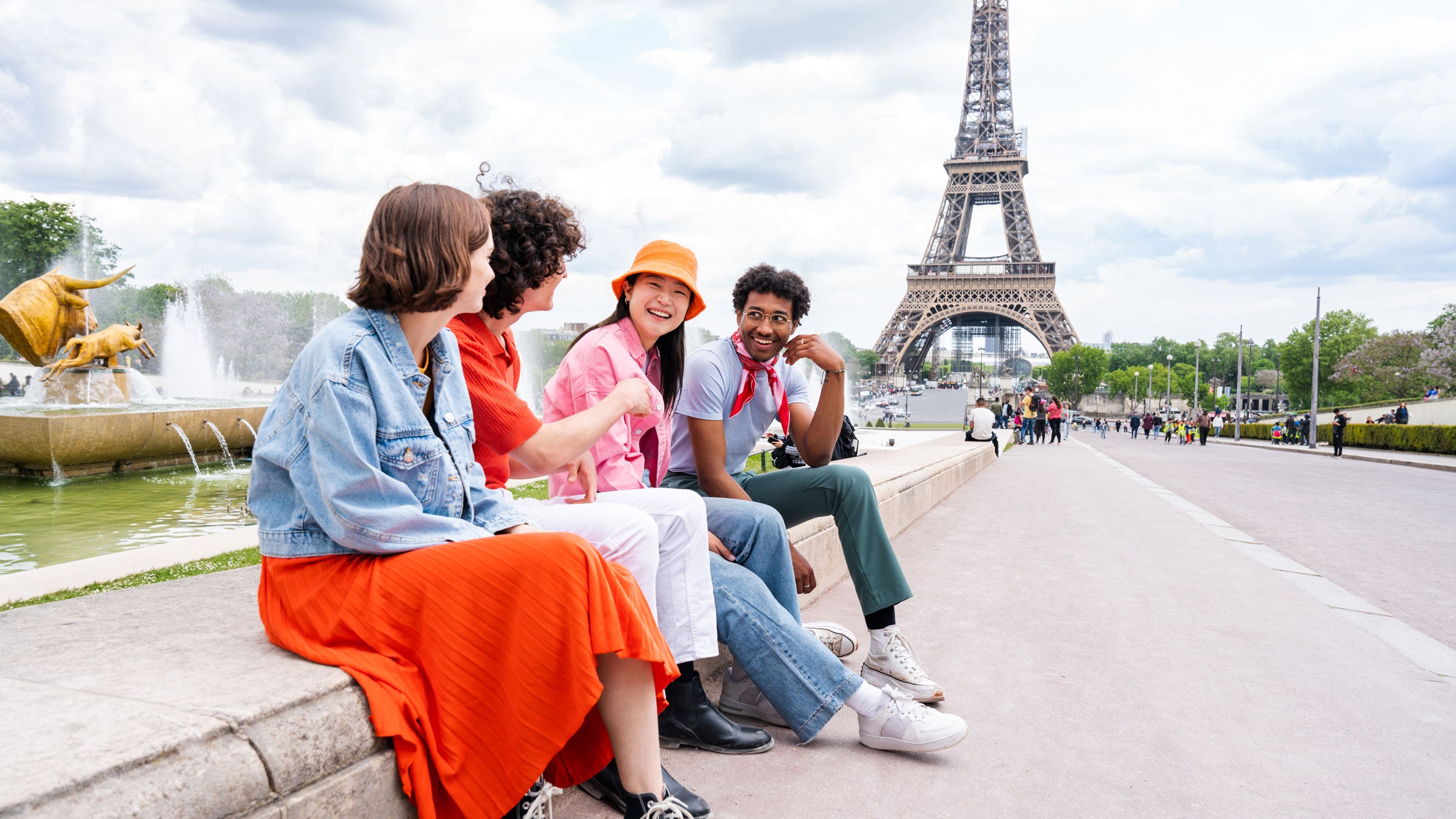 Georgia Southern students sitting in front of the Eiffel Tower on a study abroad trip learning about french culture.