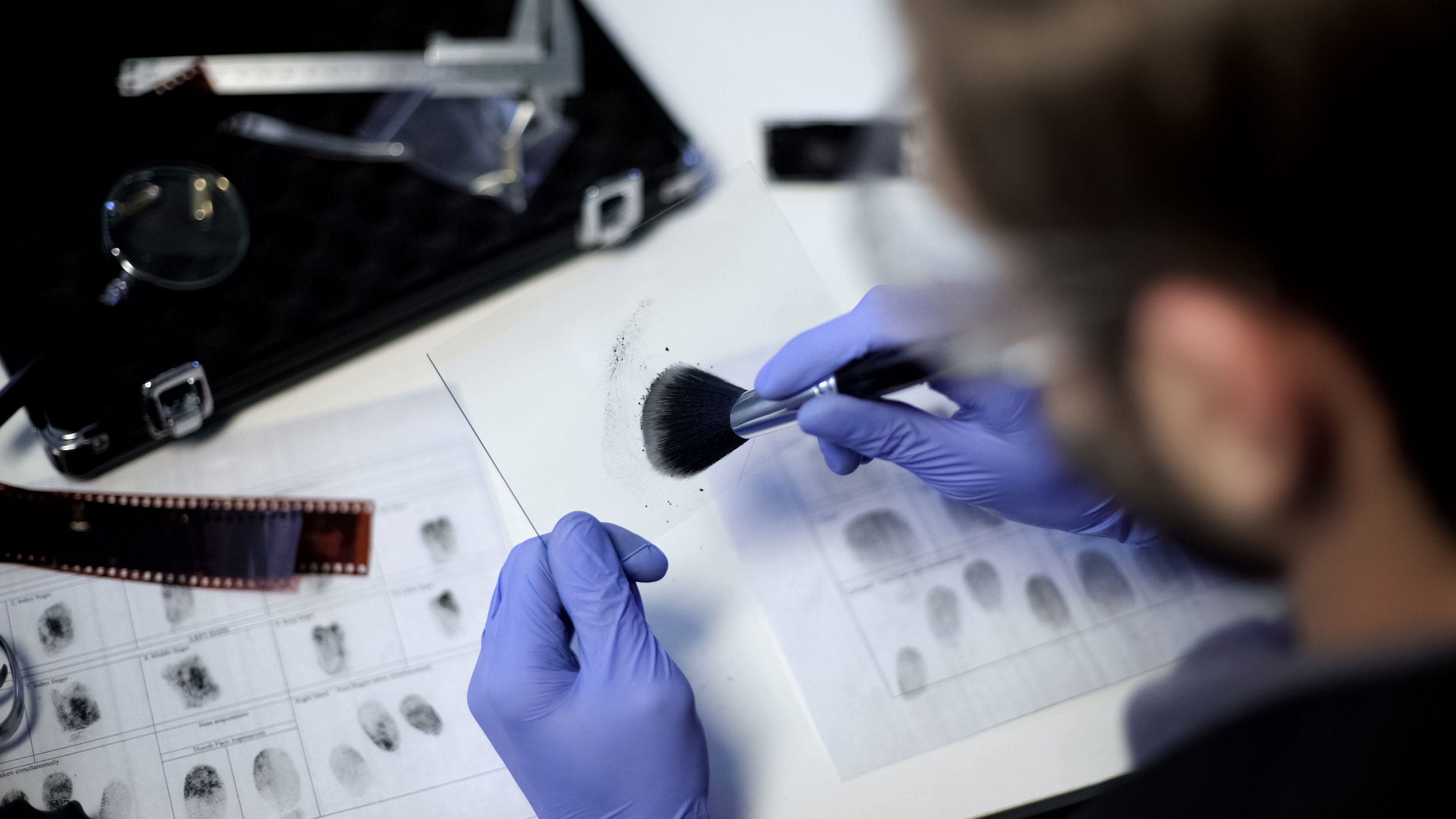 A student from Georgia Southern's M.S. in Criminal Justice and Criminology studies a sheet with fingerprints