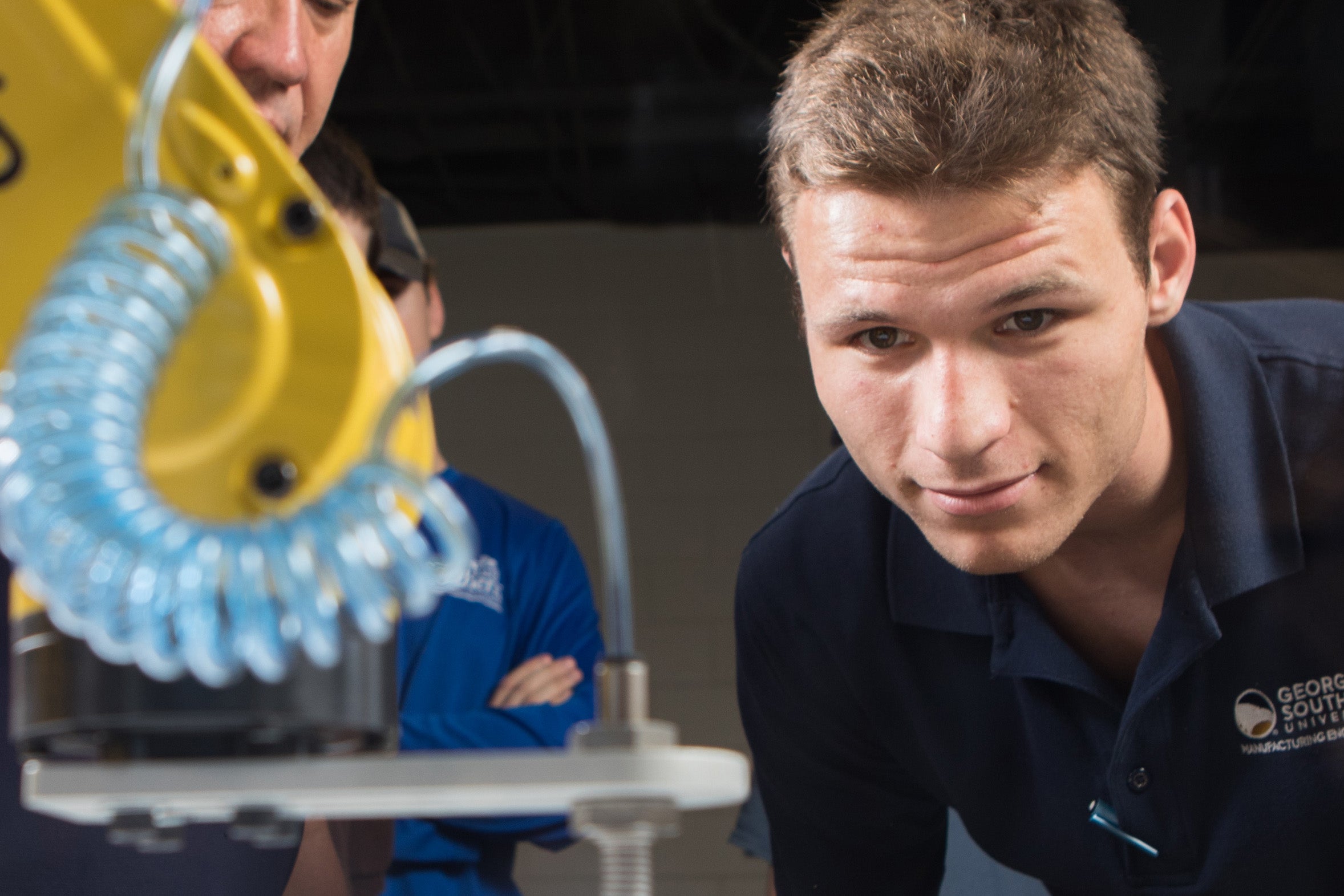 A student from Georgia Southern's M.S. in Mechanical Engineering program studies the cord passing to a piece of equipment