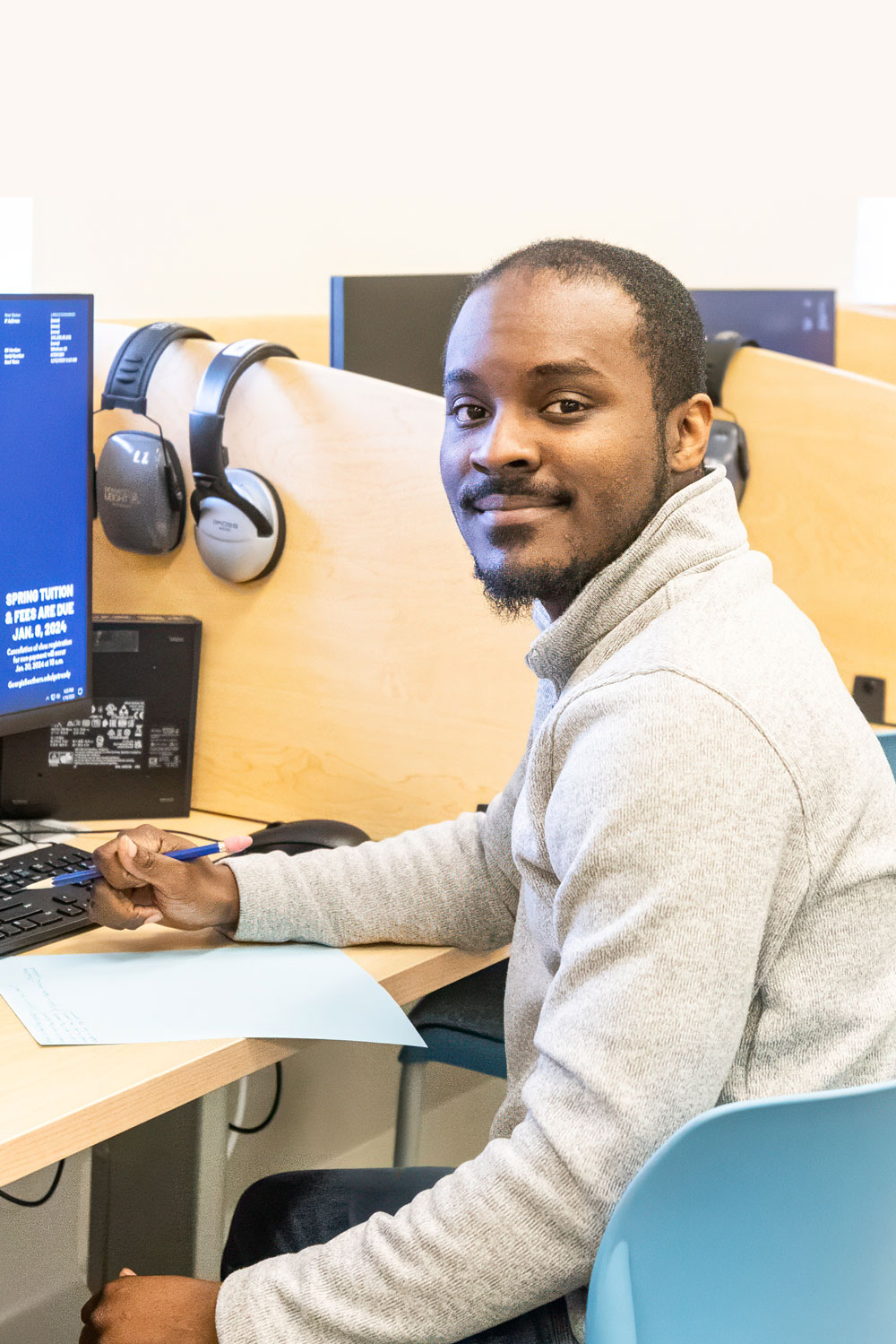 Transfer student sitting at computer in a computer lab.