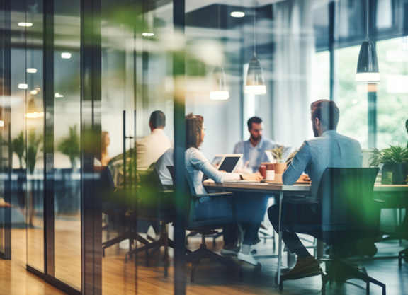 A handful of people sitting around a conference table