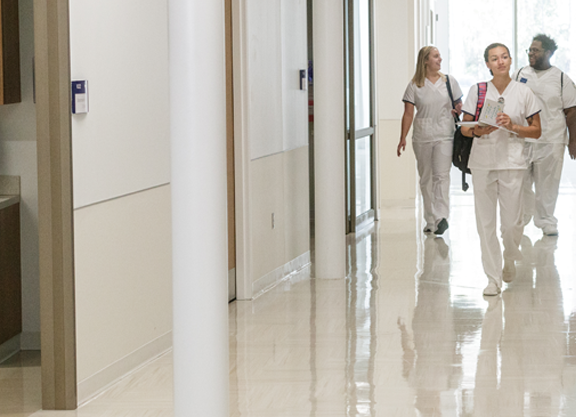 Georgia Southern nursing students walking down the hall of a hospital.