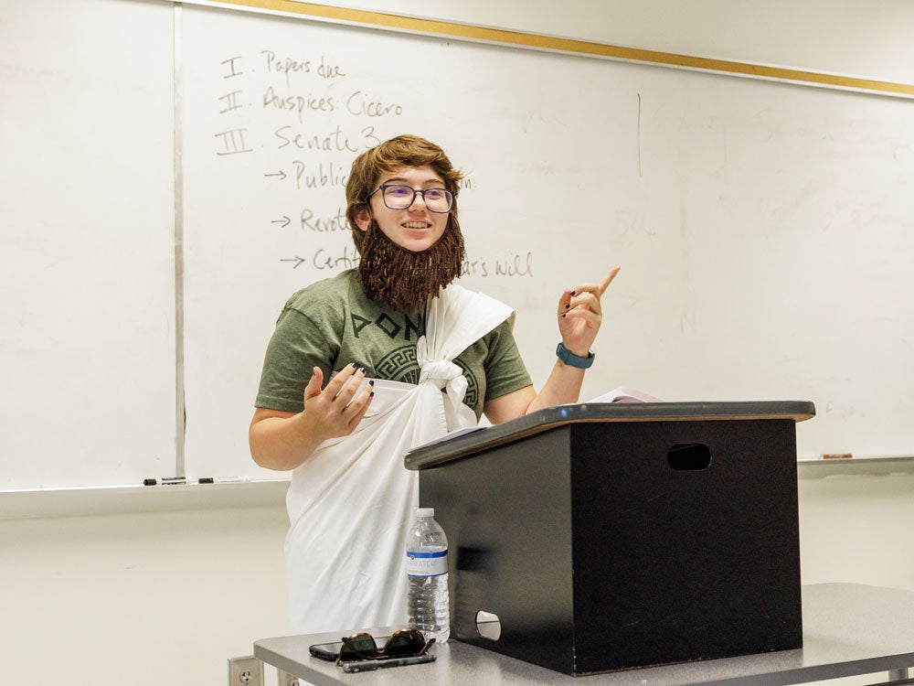 Georgia Southern student giving a presentation on historical account, showcasing a historical figure in significant era