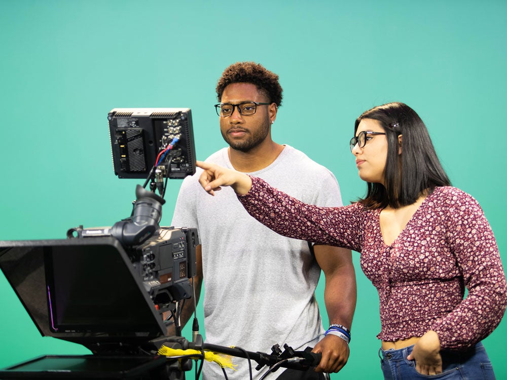 Two georgia southern students examining production equipment