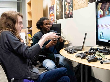 Two students playing a video game