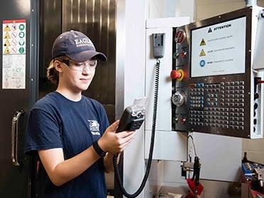 During an internship, a Georgia Southern B.S. in Electrical Engineering student wears safety glasses to use testing and monitoring equipment