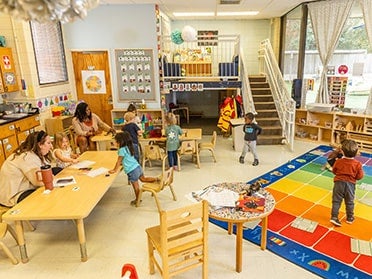 B.S. in Human Development and Family Science students help toddler and preschool age children with an activity in Georgia Southern's Child Development Center