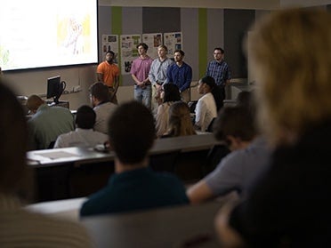 A group of Georgia Southern B.S. in Interior Design students present their project to a lecture hall of students