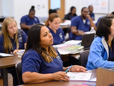 B.S. in Medical Laboratory Science students with textbooks and laptops sit in a classroom at Georgia Southern