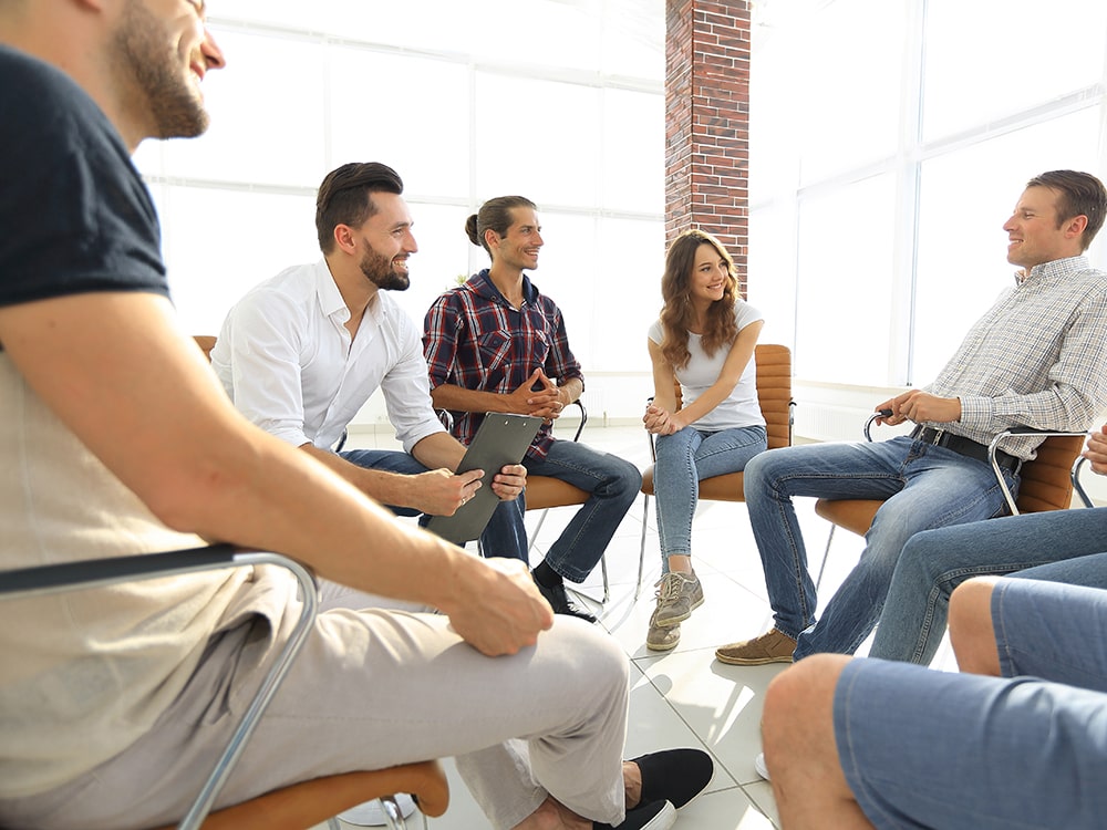 Various people seated in a circle