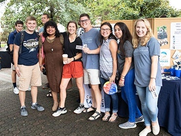 Students stand in front of posters during a student organizations and activities fair on Georgia Suothern's Statesboro Campus