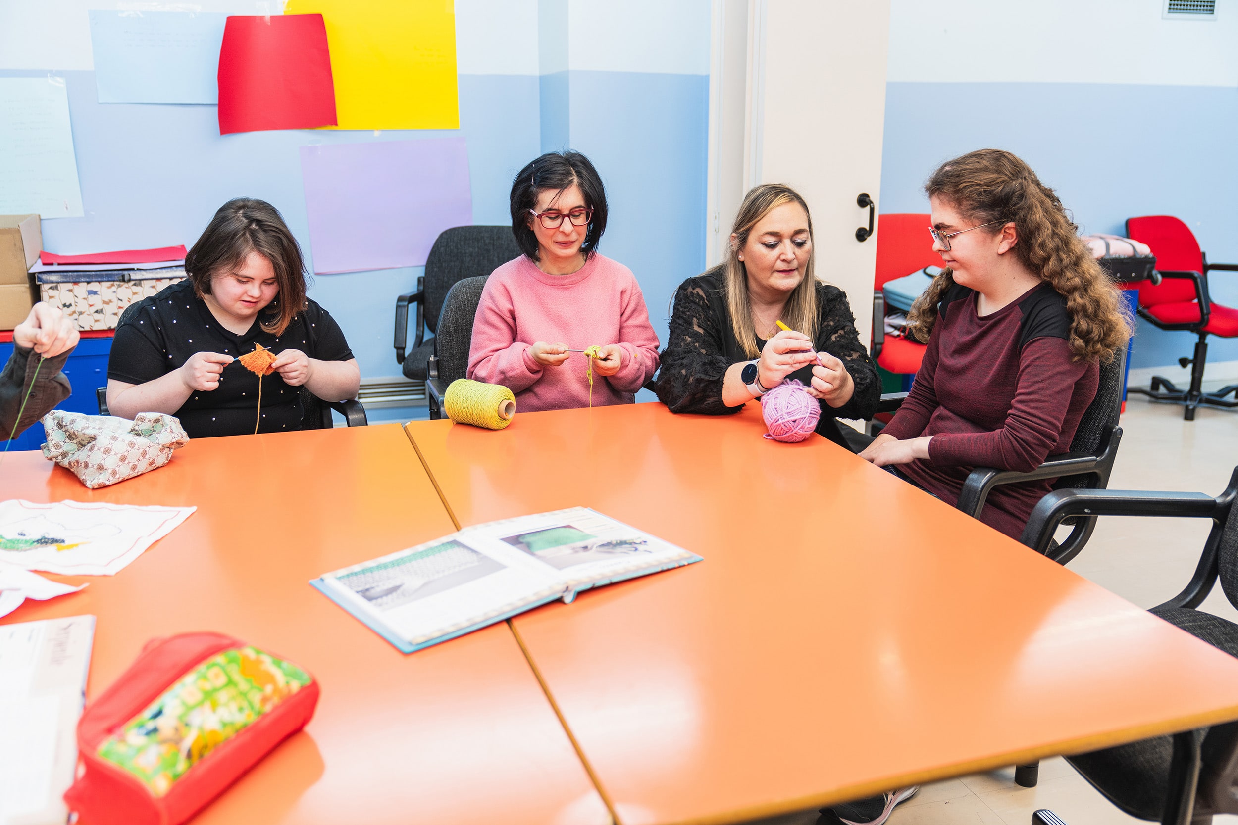 A student from Georgia Southern's M.Ed. in Special Education program helps students with a knitting activity during a practicum assignment