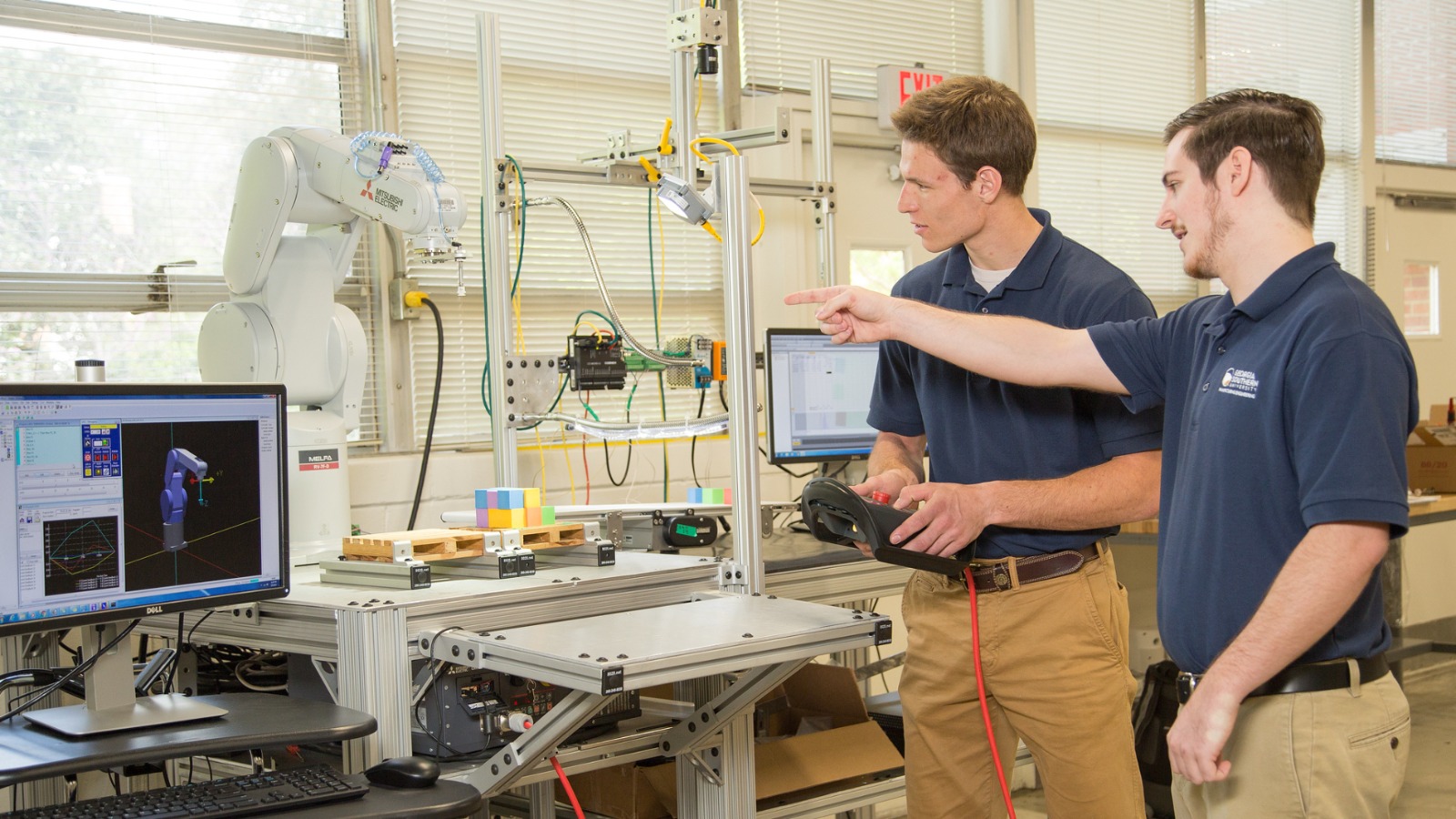 Georgia Southern researchers work with robotic manufacturing equipment in a state of the art engineering facility.