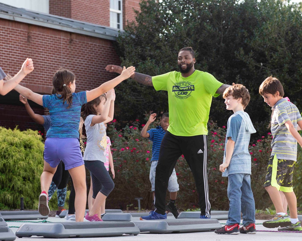 A student from Georgia Southern's B.S. in Recreation and Tourism Management program hosts a step activity for a local camp