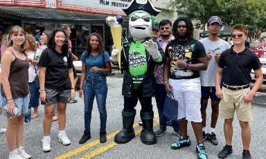 Honors Savannah Scholars hang out with the Ghost Pirates mascot.