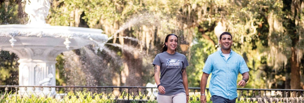 Students walk near the iconic fountain in Savannah's Forsyth Park.