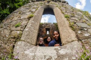 Students look out of a window in an ancient tower in Wexford, Ireland.