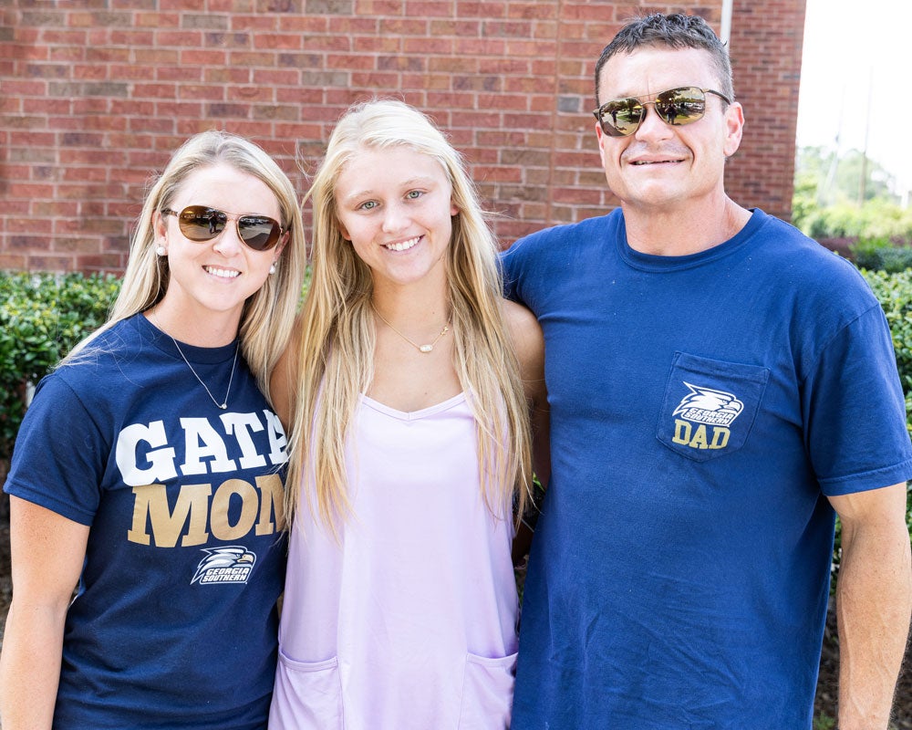 Georgia Southern student with their family on campus at an event.